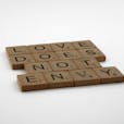 Close-Up Shot of Scrabble Tiles on a White Surface